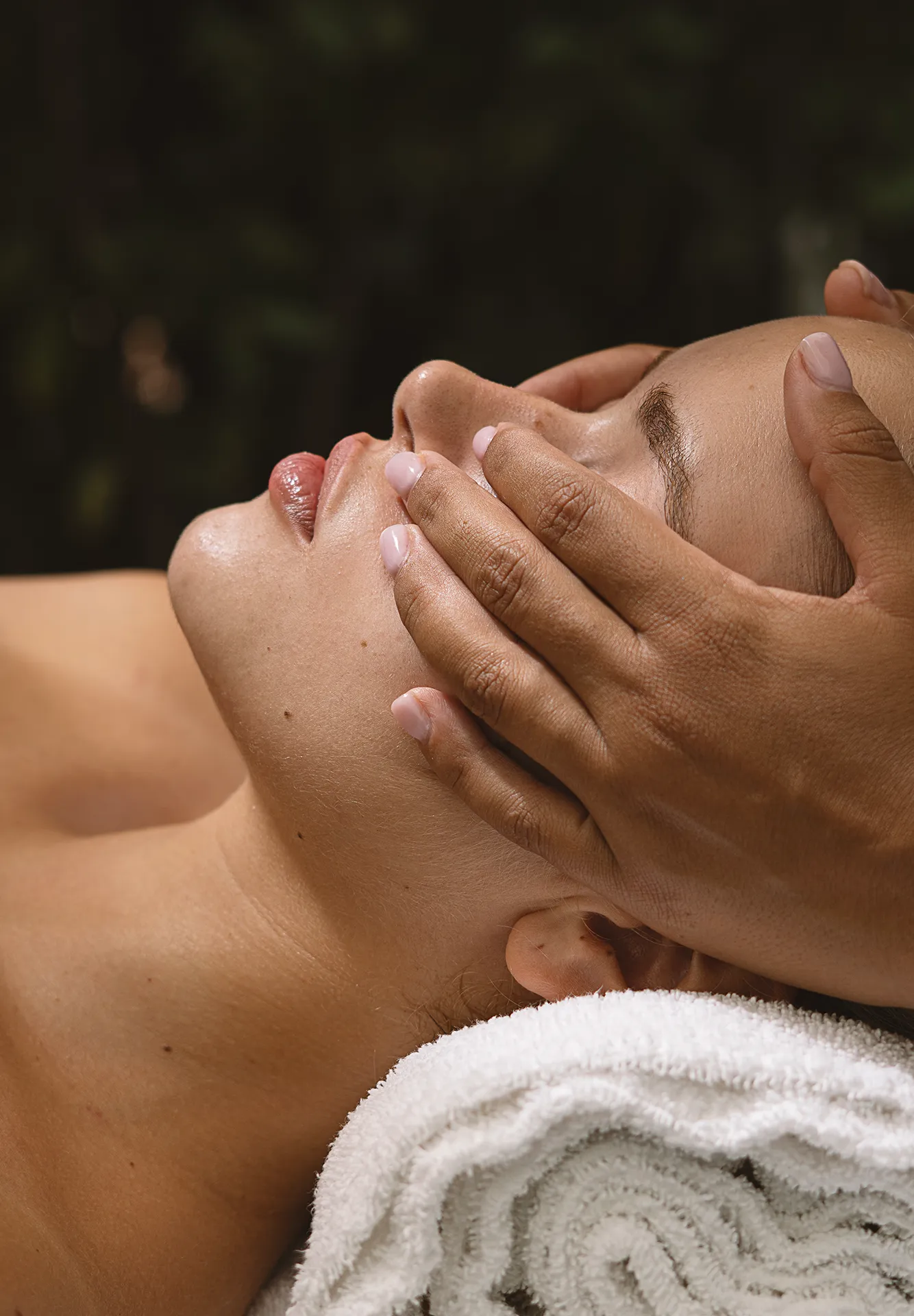 Relaxing facial and head massage treatment performed on a woman lying down at Villa Athena Spa.